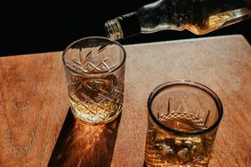 Whisky is poured into two glasses