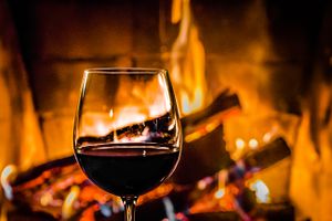 Red wine in front of a fireplace