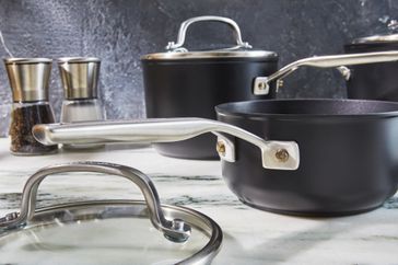 Closeup of KitchenAid Hard-Anodized 10-Piece Nonstick Cookware Set saucepan and lid while displayed on countertop