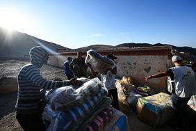 People help transporting humanitarian aids following a powerful earthquake in Mulay Brahim, Morocco on September 10, 2023