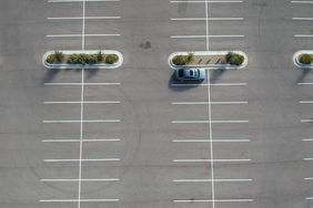 A car parked at a large parking lot.