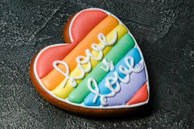 Rainbow heart cookie with the words "love is love" in icing