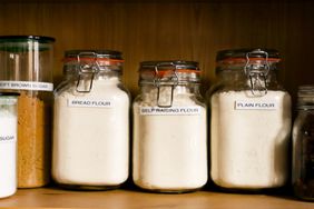 Various flours stocked in jars on a pantry shelf